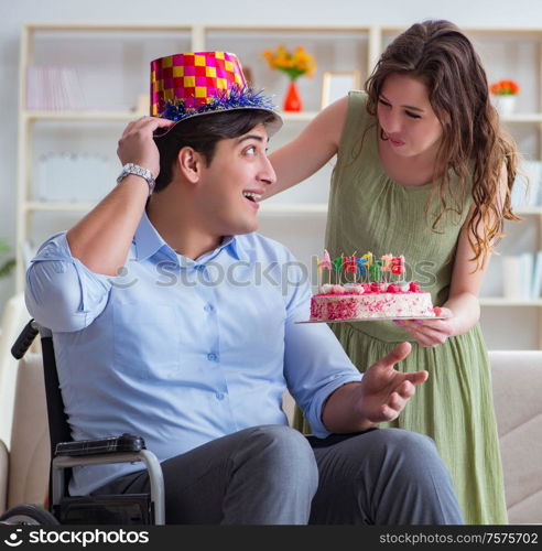 Young family celebrating birthday with disabled person. The young family celebrating birthday with disabled person
