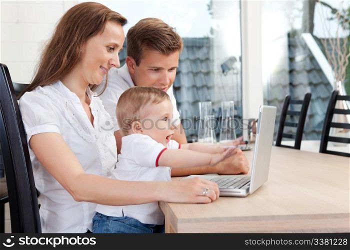 Young family chatting through computer