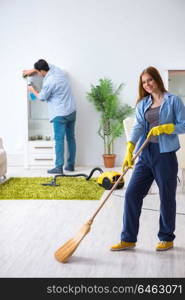 Young family cleaning the house