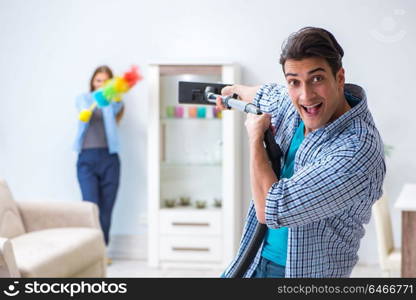 Young family cleaning the house