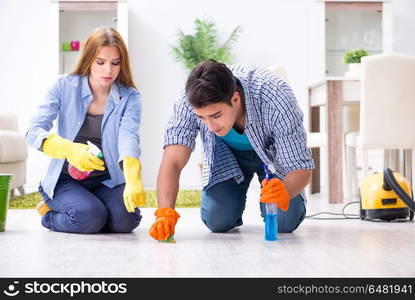 Young family cleaning the house