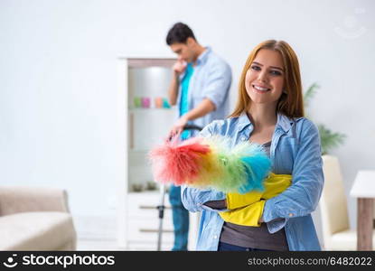 Young family cleaning the house