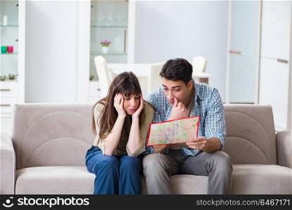Young family discussing travel plans with map