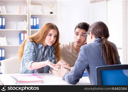 Young family dissappointed at high interest mortgage rate in bank. Young family dissappointed at high interest mortgage rate in ban
