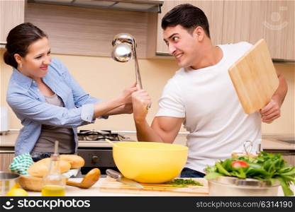 Young family doing funny fight at kitchen