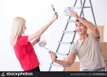 Young family doing painting job during home renovation
