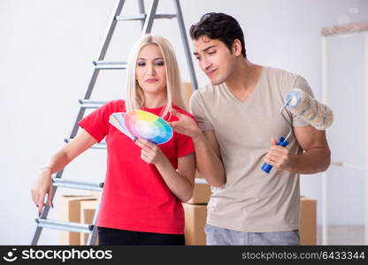 Young family doing painting job during home renovation