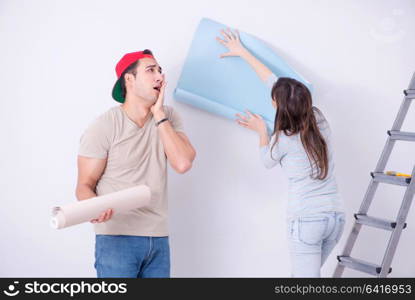 Young family doing renovation at home with new wallpaper