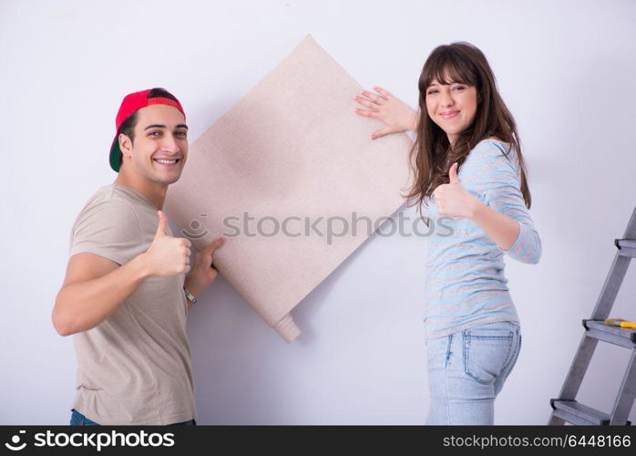 Young family doing renovation at home with new wallpaper