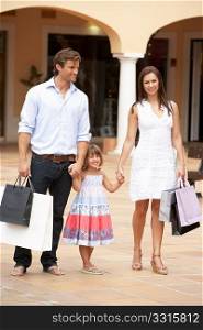 Young Family Enjoying Shopping Trip Together