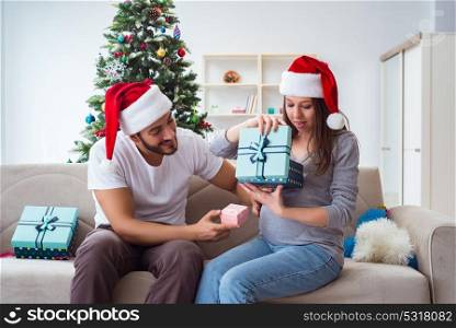 Young family expecting child baby celebrating christmas