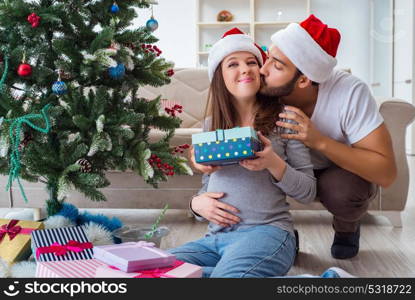 Young family expecting child baby celebrating christmas