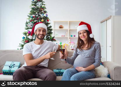 Young family expecting child baby celebrating christmas