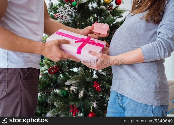 Young family expecting child baby celebrating christmas