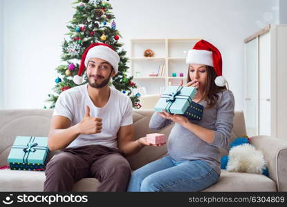 Young family expecting child baby celebrating christmas