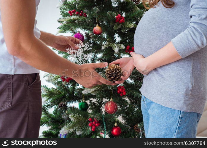 Young family expecting child baby celebrating christmas