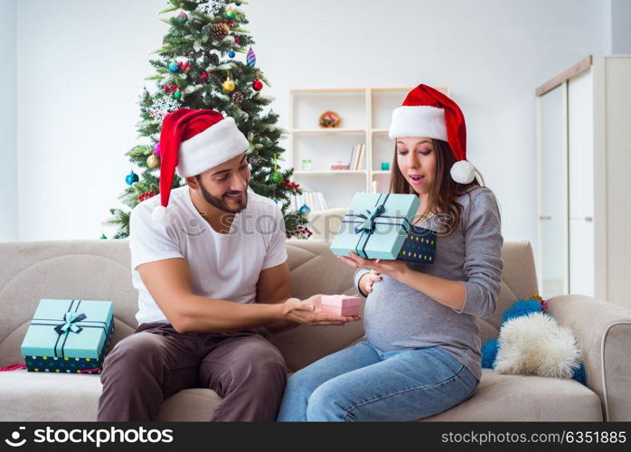 Young family expecting child baby celebrating christmas