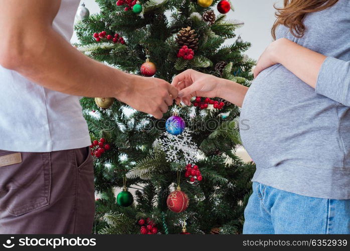 Young family expecting child baby celebrating christmas