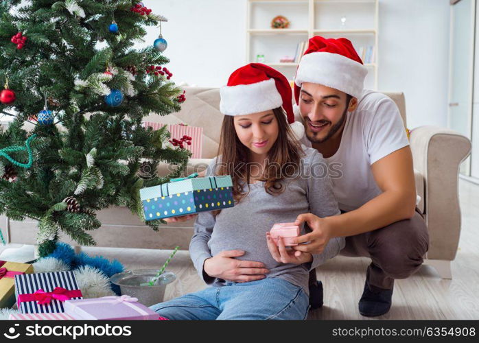 Young family expecting child baby celebrating christmas