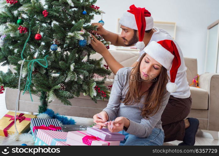 Young family expecting child baby celebrating christmas