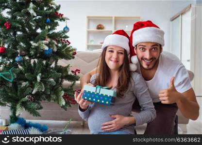 Young family expecting child baby celebrating christmas