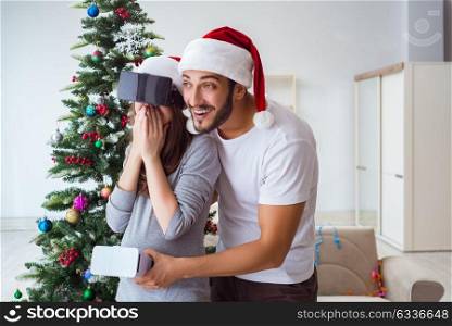 Young family expecting child baby wearing virtual reality VR glasses. Young family expecting child baby wearing virtual reality VR gla