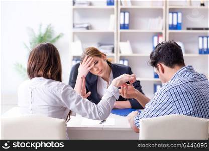 Young family filing divorce papers with lawyer
