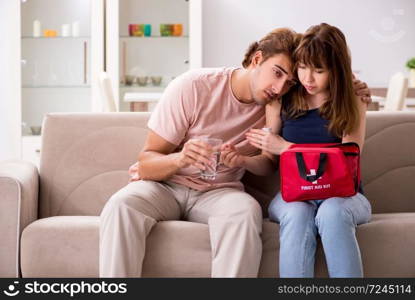 Young family getting treatment with first aid kit