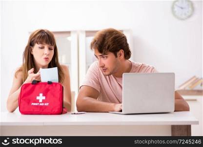 Young family getting treatment with first aid kit
