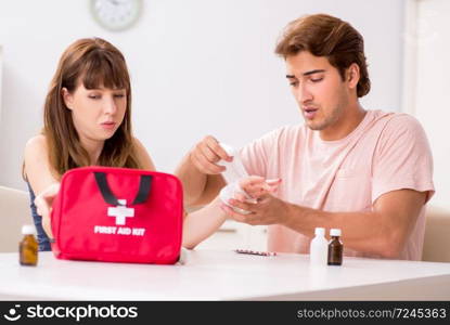 Young family getting treatment with first aid kit