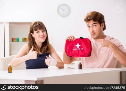 Young family getting treatment with first aid kit