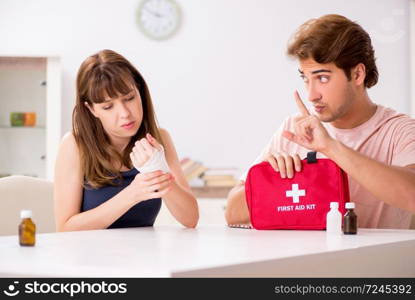 Young family getting treatment with first aid kit