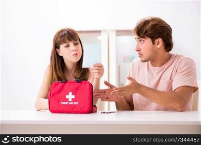 Young family getting treatment with first aid kit