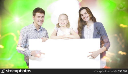 Young family. Happy family of three holding white blank banner. Place for text