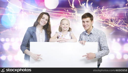 Young family. Happy family of three holding white blank banner. Place for text