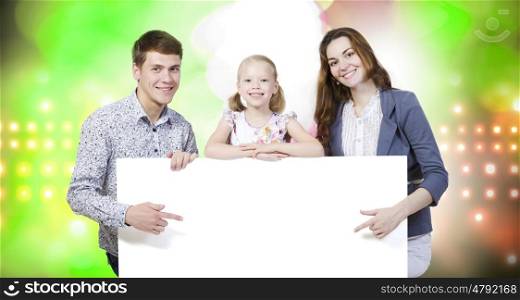 Young family. Happy family of three holding white blank banner. Place for text