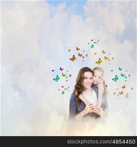 Young family. Happy mother with daughter sitting on clouds