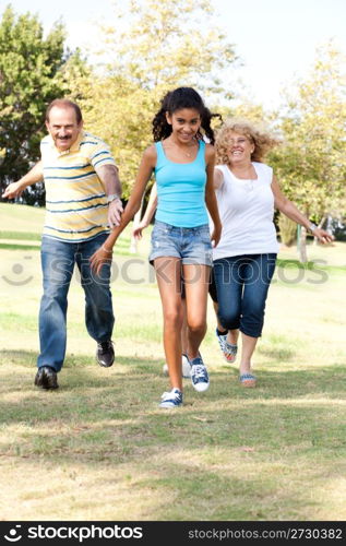 Young family having fun in park...