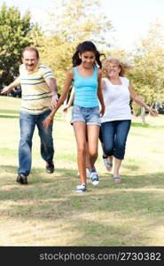 Young family having fun in park...