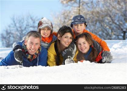 Young Family Having Fun In Snowy Landscape