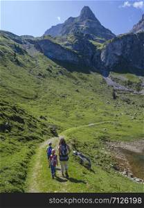 Young family hiking around Bannalp in Nidwalden Switzerland on a summer day.