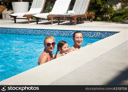 Young family in swimming pool together