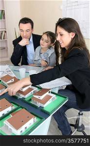 Young family looking at model housing