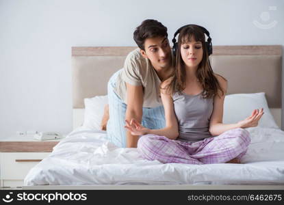 Young family meditating in the bed bedroom