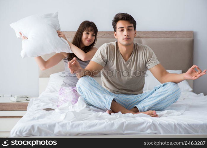 Young family meditating in the bed bedroom