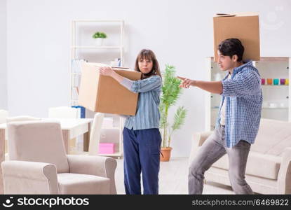 Young family moving in to new apartment after paying off mortgage