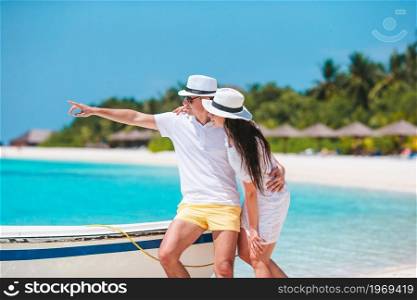 Young family of two on white beach enjoy vacation. Young couple on white beach during summer vacation.