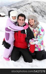Young family on a snowy mountain