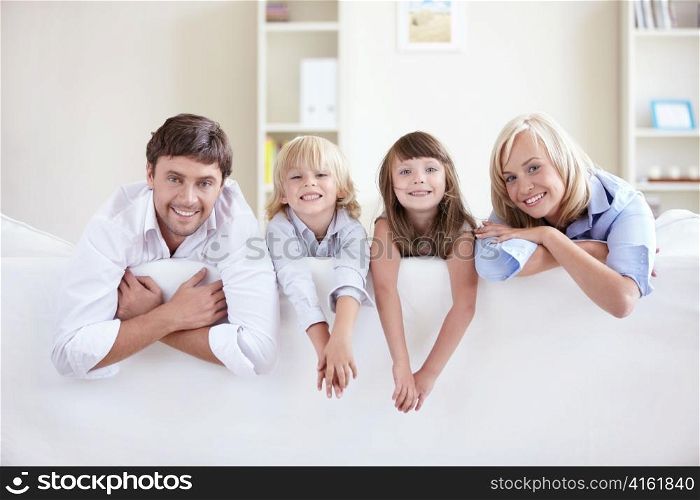 Young family on a white sofa