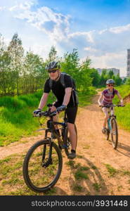 Young family on bike exercising on a country road